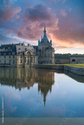 Chantilly castle, in France, beautiful palace with a lake 