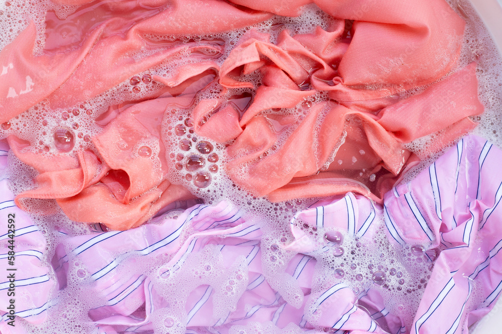 Fototapeta premium Top view of formal shirts soak in powder detergent water dissolution. Laundry concept