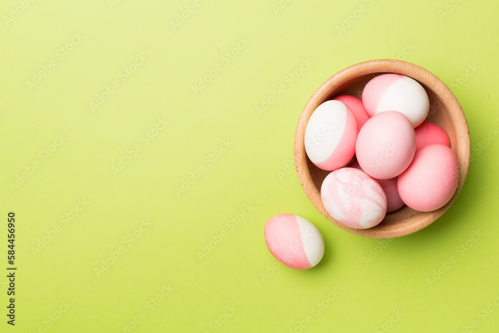 Pink Easter eggs with decor on color background, top view