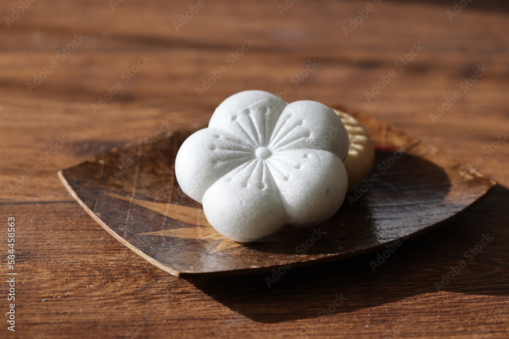 Japanese confectionery called Monaka which Bean jam filled wafers on a plate on a wooden table. Japanese confectionery called Monaka which Bean jam filled wafers on a plate on a wooden table.
