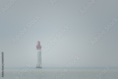 Chauveau lighthouse, isle of Re, at low tide on a foggy day photo
