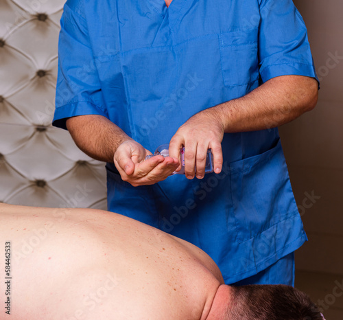 The doctor practices therapeutic massage, vacuum massage and hijama