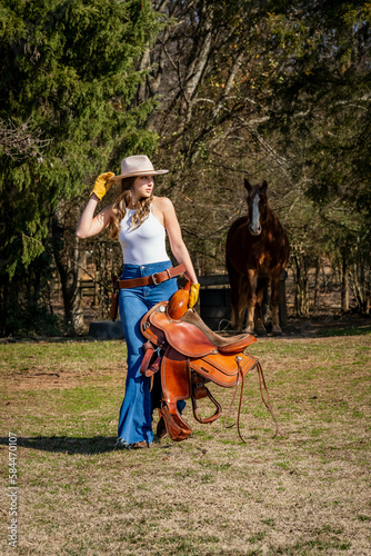 Lovely Brunette Cowgirl Enjoying A Day With Her Horse On Her Farm