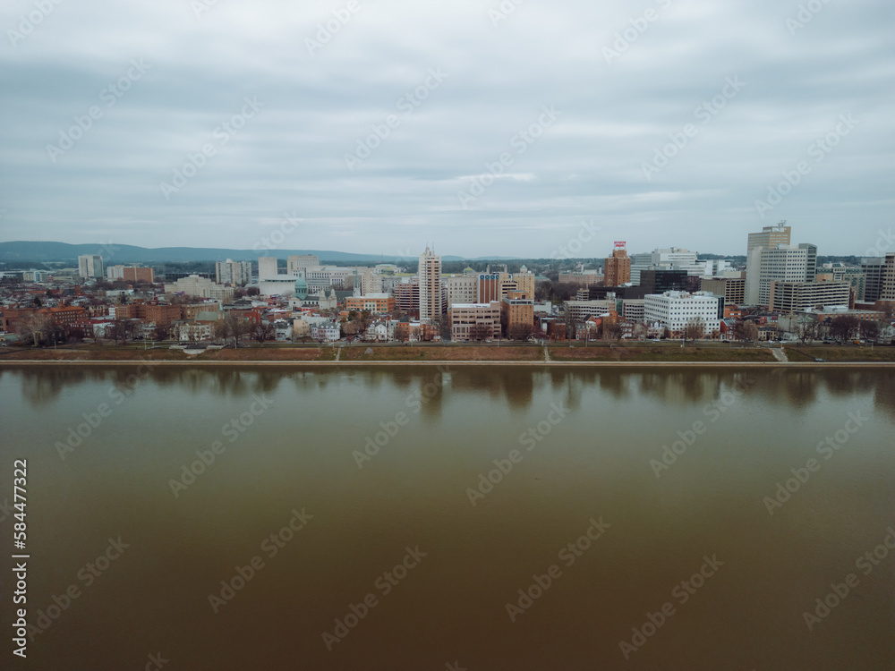 Aerial drone view of city along river. 