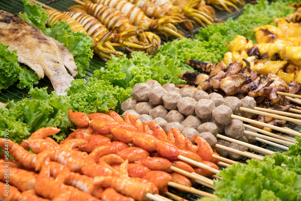 Grilled and BBQ skewer foods place on the tray on market for sell Grilled and BBQ skewer foods place on the tray on market for sell