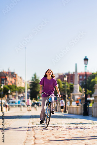 sustainability eco transport lifestyle. uruguayan mid latina woman ride a bike outside in the city
