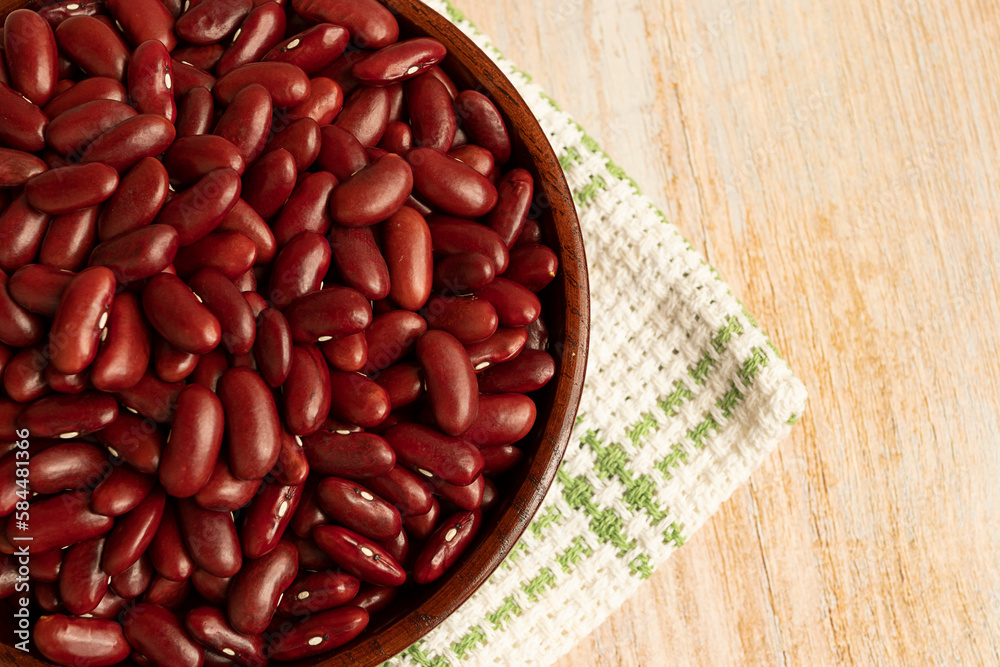 Bowl filled with Kidney beans shot on rustic wood table. Top view Bowl filled with Kidney beans shot on rustic wood table. Top view