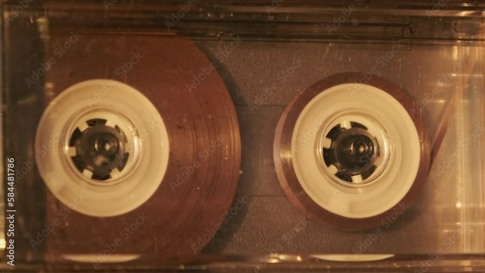 Audio cassette playback in vintage tape recorder. Record player playing