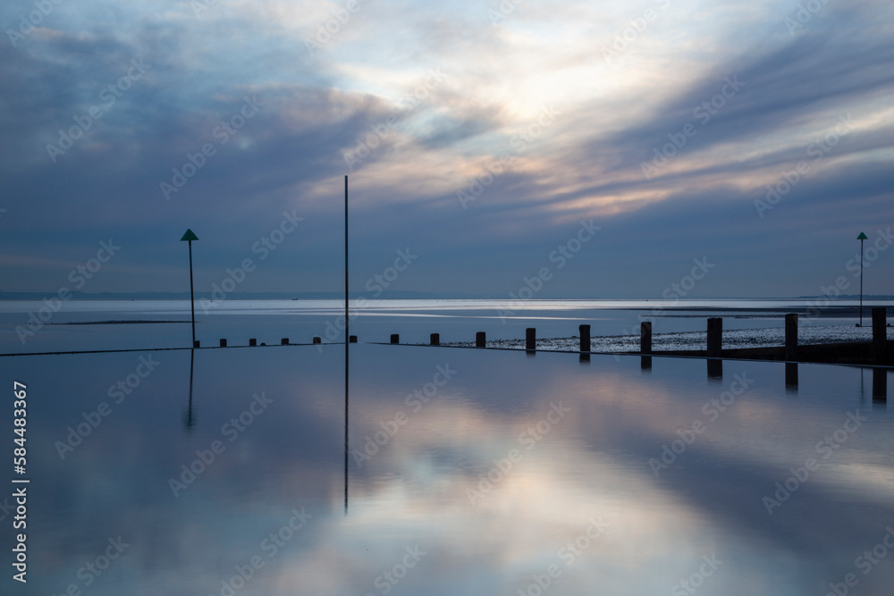 Reflections on Westcliff beach, Essex, England, United Kingdom