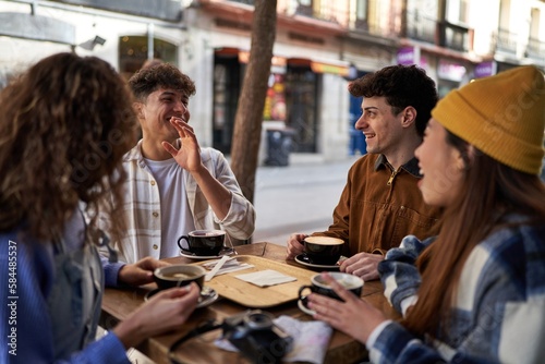 A multicultural group of friends enjoying coffee and tea after their vacation.