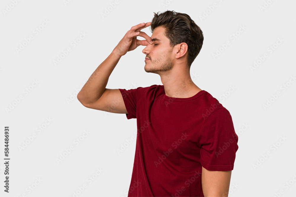 Young handsome caucasian man isolated on white background having a head ache, touching front of the face. Young handsome caucasian man isolated on white background having a head ache, touching front of the face.
