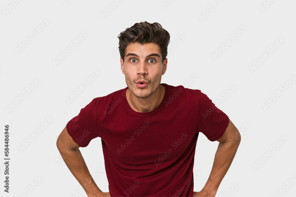 Young handsome caucasian man isolated on white background being shocked because of something she has seen.