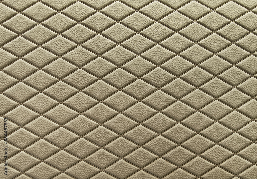 Naklejka premium Khaki leather background and texture as a pattern for the interior car or a sofa or wall covering