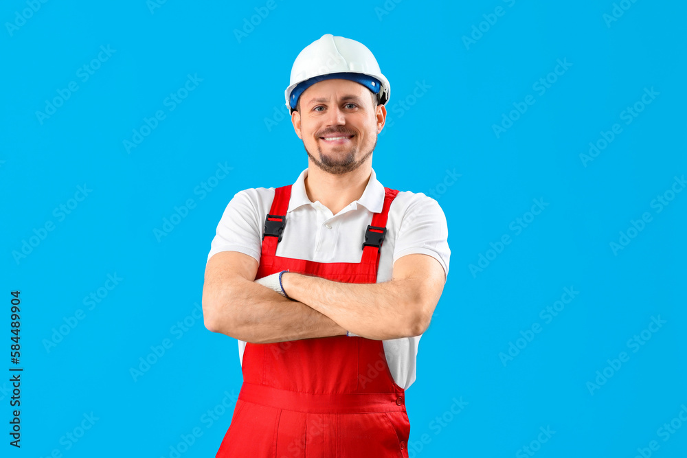 Male carpenter in hardhat on blue background Male carpenter in hardhat on blue background
