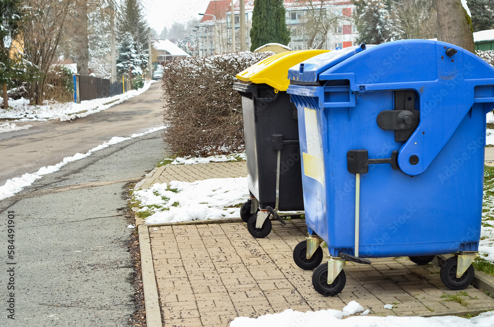 View of garbage containers in city on winter day View of garbage containers in city on winter day