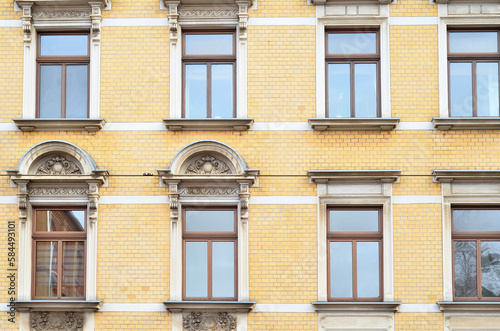 View of brick building with wooden windows © Pixel-Shot