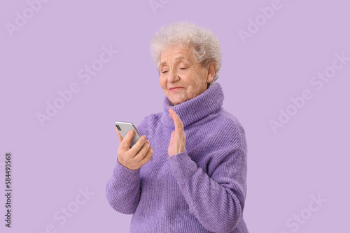Senior woman with mobile ph...