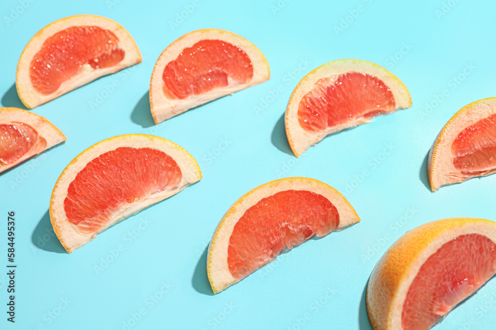 Composition with pieces of ripe grapefruit on color background, closeup Composition with pieces of ripe grapefruit on color background, closeup
