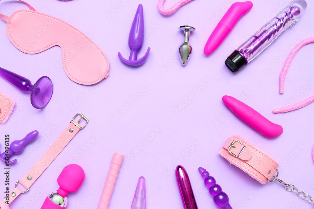 Frame made of sex toys on lilac background Frame made of sex toys on lilac background