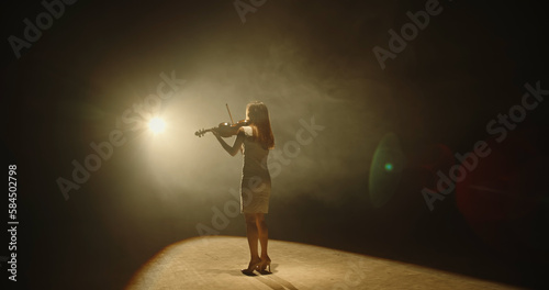 Canvas Print Professional female violinist performing a solo concert on stage