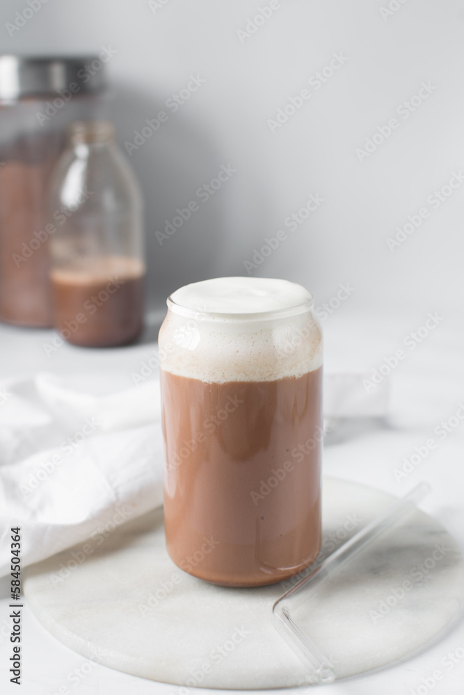 Mocha latte with whipped cream in a can shaped glass, iced mocha with foam and chocolate syrup Mocha latte with whipped cream in a can shaped glass, iced mocha with foam and chocolate syrup
