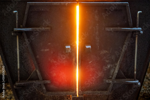 Maple sugaring wood fired boiler glowing red hot, Ontario, Canada