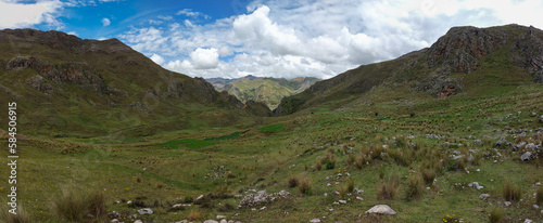 HUANCAVELICA, PERU - MARCH 23, 2023: Panoramic view of a natural landscape located near the city of Huancavelica. Blue sky, cumulus clouds, pampa and vegetation.