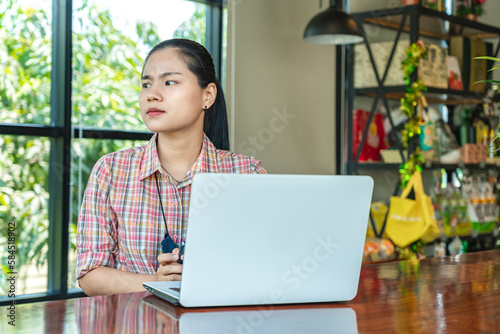 Concentrated woman waiting for business meeting or learning online. Serious, frustrated and thinking while waiting and working on laptop. Student learning online. Freelancer working online