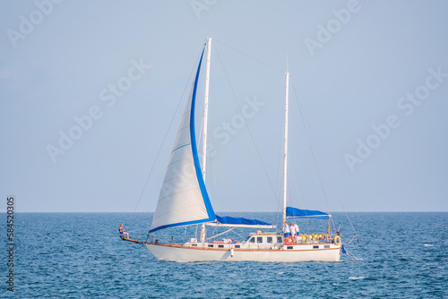 Sailing yacht in the blue calm sea.