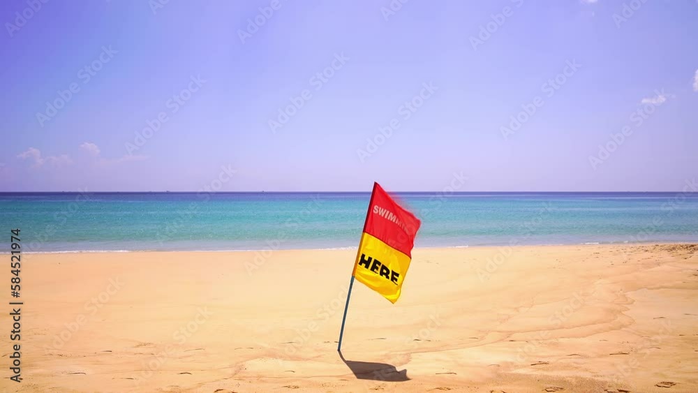 Swimming here flag at Phuket patong beach and waves crashing against empty beach on March,2023 Beautiful summer beach in Phuket Thailand, Patong Beach famous tourist destination Swimming here flag at Phuket patong beach and waves crashing against empty beach on March,2023 Beautiful summer beach in Phuket Thailand, Patong Beach famous tourist destination