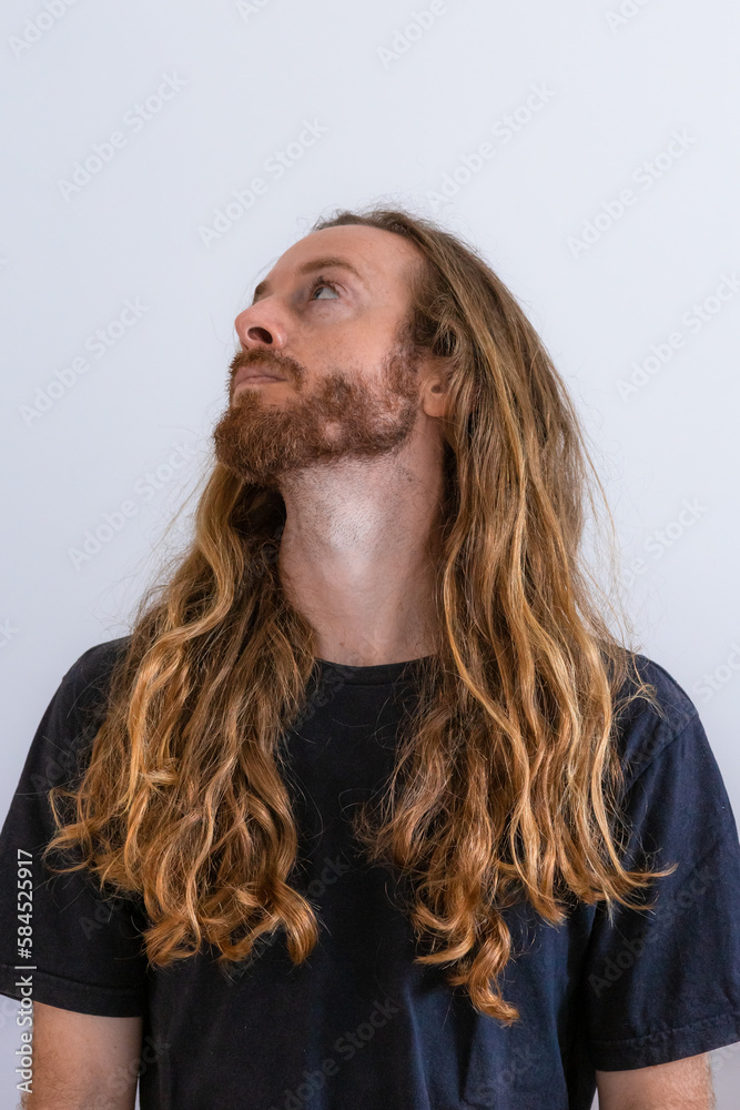 Blond long hair white man wearing black t shirt on white background Blond long hair white man wearing black t shirt on white background