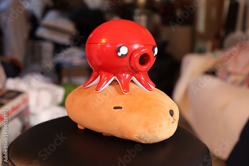 3d printed red tako octopus on top of capybara plush photo