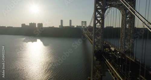 Aerial view flying paralell to the George Washington bridge, sunset above Jersey, USA - reverse, drone shot photo