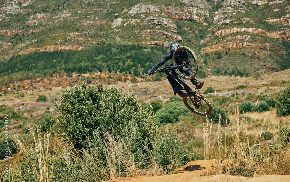 Jump, extreme sports and mountain bike with man in nature for cycling, fitness and adventure. Adrenaline junkie, performance and stunt with athlete riding in outdoors for action, risk and training Jump, extreme sports and mountain bike with man in nature for cycling, fitness and adventure. Adrenaline junkie, performance and stunt with athlete riding in outdoors for action, risk and training