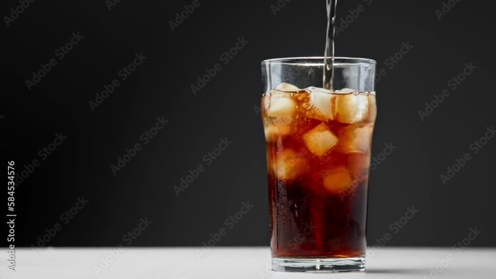Drinking Coca Cola of Glass Cup with Ice and Wet Surface Close Up. Drink Sparkling Beverage or Diet Coke on Studio Shot in Macro. Eating of Colourful Pub Meal or Fast Food Isolated on Dark Background Drinking Coca Cola of Glass Cup with Ice and Wet Surface Close Up. Drink Sparkling Beverage or Diet Coke on Studio Shot in Macro. Eating of Colourful Pub Meal or Fast Food Isolated on Dark Background