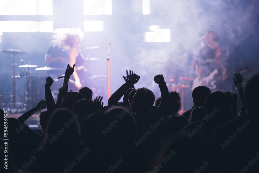 Crowd at concert and blurred stage lights.