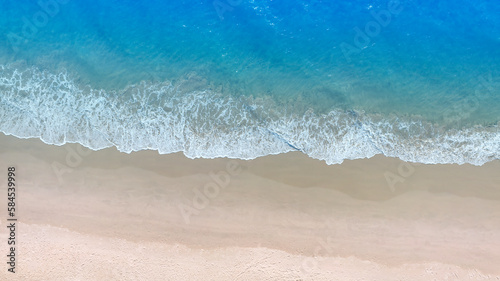 Aerial view with beach in wave of turquoise sea water shot, Top view of beautiful white sand background © SASITHORN