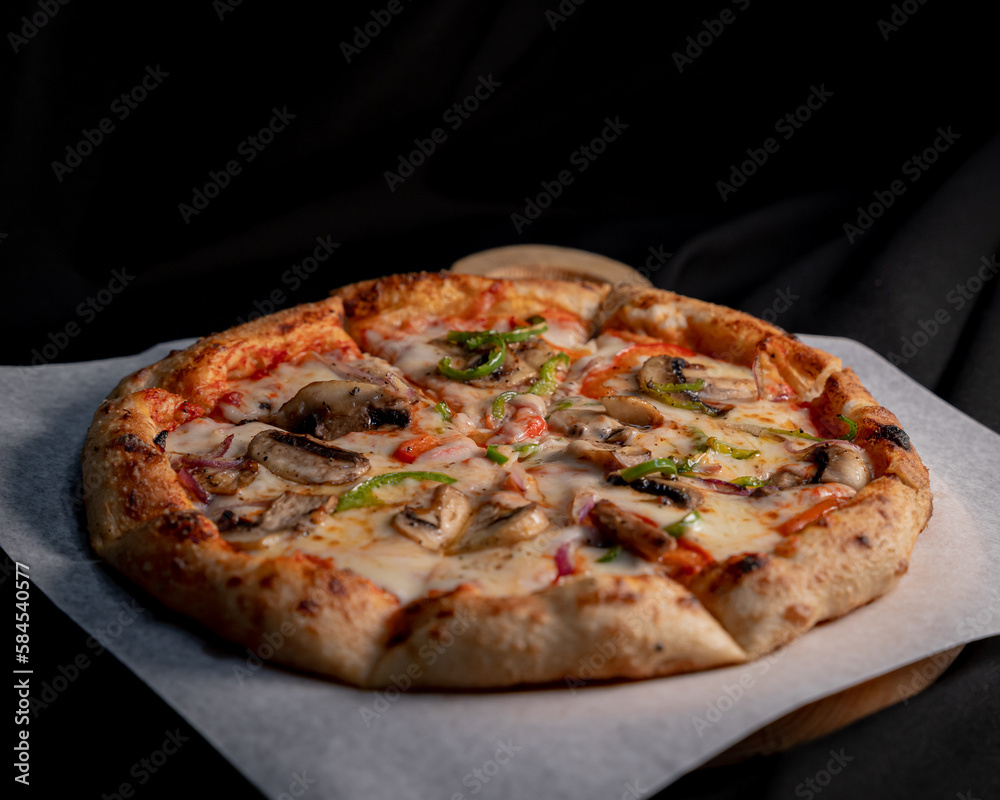 Delicious Italian pizza with fresh ingredients on a wooden board.