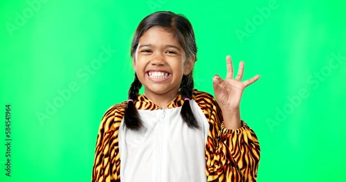 Children, perfect and hand gesture with a girl on a green screen background in studio feeling good. Portrait, smile and emoji with an adorable happy female child on chromakey mockup looking positive photo