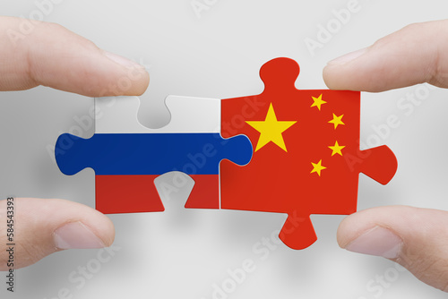 Puzzle made from flags of Russia and China. Russia and China relations and military collaboration photo