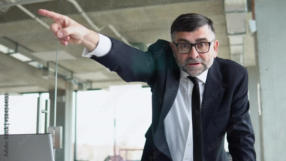 Angry senior boss shouts at the camera to the employee points his finger to the side dismisses the subordinate. Old director dismisses the employee Angry senior boss shouts at the camera to the employee points his finger to the side dismisses the subordinate. Old director dismisses the employee