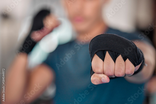 Man, fist and boxing, fitness and martial arts in gym, exercise and power, strong person and punch. Workout, male boxer training in combat and sports, athlete ready to fight and mma fighter hand zoom