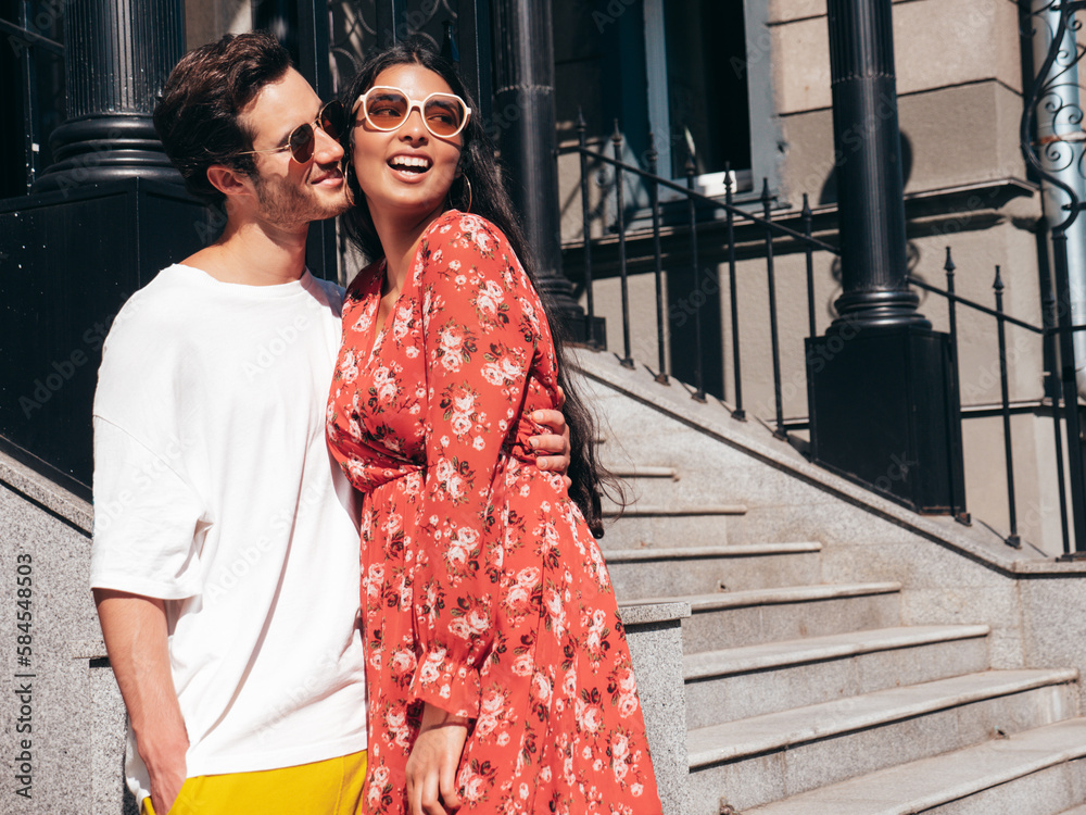 Smiling beautiful woman and her handsome boyfriend. Happy cheerful family. Sexy couple posing in the street at sunrise. During romantic date at sunny summer day outdoors. Looking at each other Smiling beautiful woman and her handsome boyfriend. Happy cheerful family. Sexy couple posing in the street at sunrise. During romantic date at sunny summer day outdoors. Looking at each other