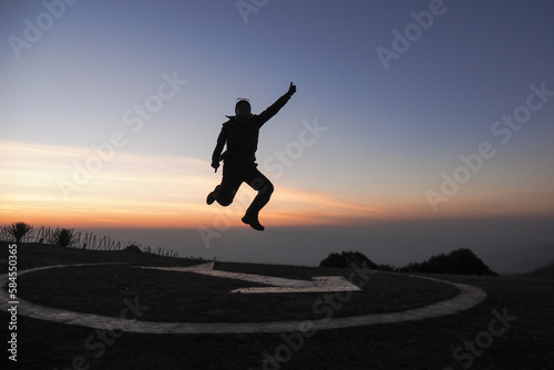 Wallpaper Mural The silhouette of a man is jumping forward. on the mountain Torontodigital.ca