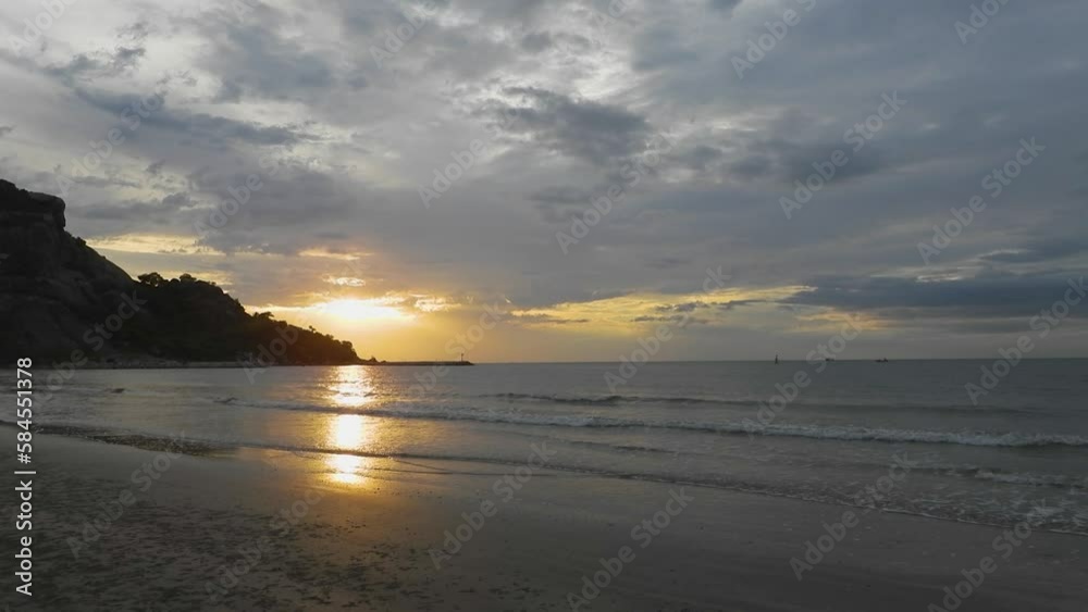 sunrise on a cloudy rainy morning sky sea with mountains, Sea waves motion, Beach and sea, summer relaxation concept. sunrise on a cloudy rainy morning sky sea with mountains, Sea waves motion, Beach and sea, summer relaxation concept.