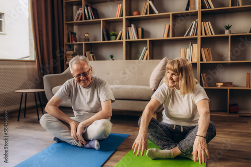 retired married couple exercising at home © Roman