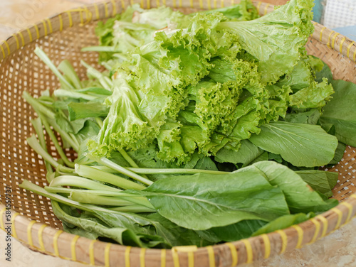 fresh lettuce and choy sum in a traditional bamboo basket