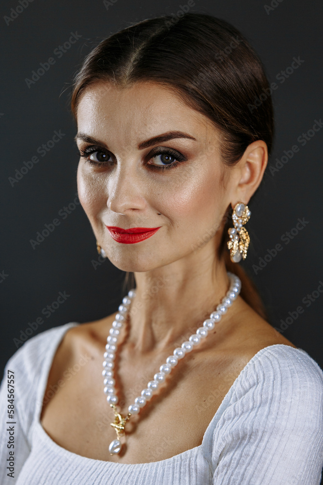 A woman in a white sweater on a gray background A woman in a white sweater on a gray background