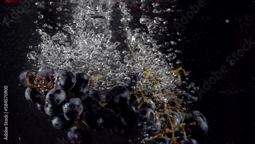 Super slow motion of falling strawberry, raspberry, bog bilberry, blueberry into splashing water. Fresh Juice cooking concept. Filmed on high speed cinema camera, 4k 1000 fps. photo