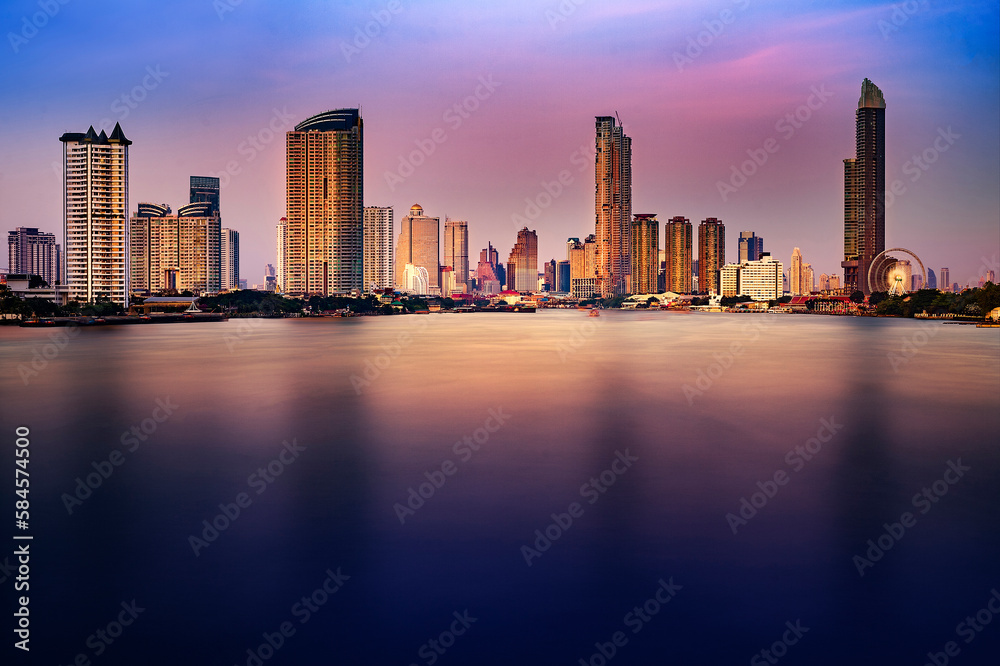Bangkok city skyline at sunset with River view and sky scraper and ferris wheel romantic atmosphere in Thailand 